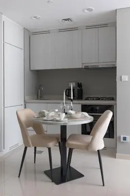 a kitchen with a table and chairs in a kitchen at Modern and Cozy 1BR in Business Bay in Dubai