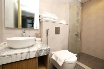 a bathroom with a sink and a toilet and a shower at Chic Aykon City 2-Bedroom Retreat - Business Bay in Dubai