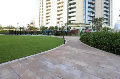 a park with a playground in front of a building at Chic Aykon City 2-Bedroom Retreat - Business Bay in Dubai