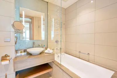 a bathroom with a tub and a sink and a shower at Spacious 3BHK in Paramount Tower B with Stunning Views-6204 in Dubai