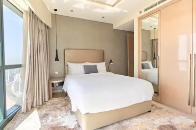 a bedroom with a white bed and a large window at Spacious 3BHK in Paramount Tower B with Stunning Views-6204 in Dubai