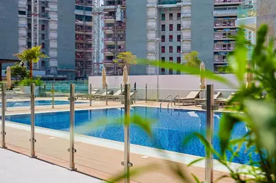 a swimming pool on the roof of a building at Urban Oasis - Cosy Studio Retreat in Dubai
