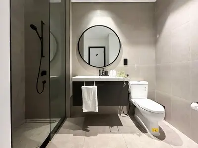 a bathroom with a toilet and a sink and a mirror at Modern Marvel Studio in Business Bay in Dubai