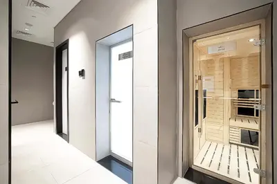 a hallway with a walk in closet with a glass door at Modern Marvel Studio in Business Bay in Dubai
