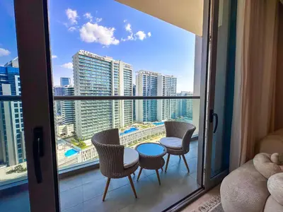 a room with a balcony with a view of the city at Chic 1-Bedroom in Sterling Tower, Downtown Stay - 17AB05 in Dubai