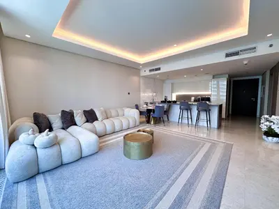 a living room with a white couch and a table at Chic 1-Bedroom in Sterling Tower, Downtown Stay - 17AB05 in Dubai