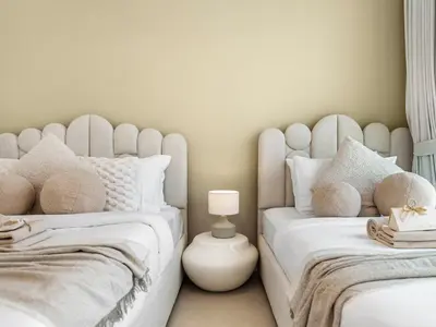 two beds sitting next to each other in a bedroom at Apartment in Downtown Dubai in Dubai