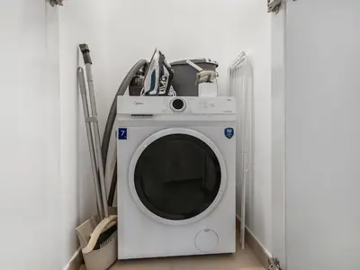 a white washing machine sitting in a laundry room at Apartment in Downtown Dubai in Dubai