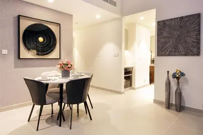 a dining room with a table and chairs at Downtown Luxury - Stunning 2BHK with Sea view in Forte towers, Downtown in Dubai