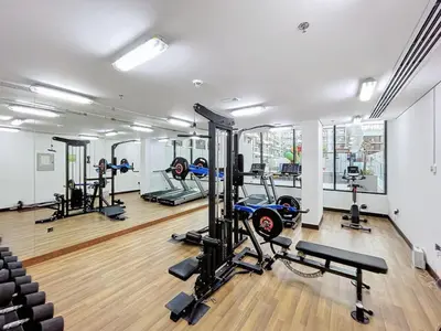 a gym with several treadmills and tread machines at Locations I Avanos Residence I Premium Modern 1BR I Cosy & Comfortable I Near Parks, Shops & Cafés in JVC in Dubai