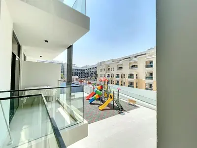 an empty balcony with a playground on a building at Locations I Avanos Residence I Premium Modern 1BR I Cosy & Comfortable I Near Parks, Shops & Cafés in JVC in Dubai