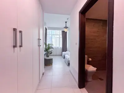 a hallway leading to a living room with a toilet at Luxurious 2BR in Vezul Residence, Business Bay - 13AB01 in Dubai