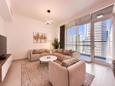 a living room with a couch and a table at Luxurious 2BR in Vezul Residence, Business Bay - 13AB01 in Dubai