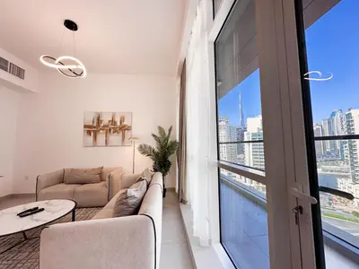 a living room with a couch and a table at Luxurious 2BR in Vezul Residence, Business Bay - 13AB01 in Dubai