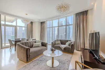 a living room with two couches and a television at Spacious 3BDR Apartment in Marina with Office in Dubai
