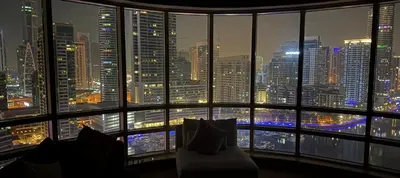 a room with a view of a city at night at 2 Bedroom Apartment full Marina View in Dubai