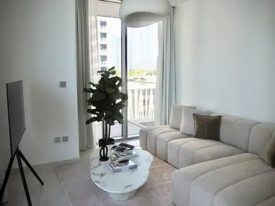 a living room with a couch and a table at BrandNew, OceanView, PrivateBeach, 1bed in Dubai