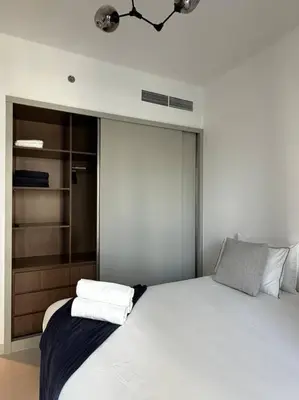 a bedroom with a bed with two towels on it at BrandNew, OceanView, PrivateBeach, 1bed in Dubai