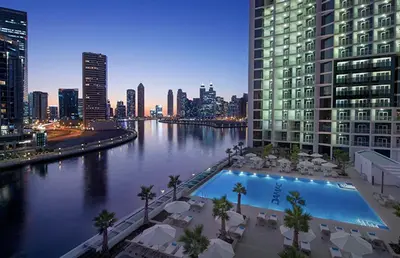 a view of a river in a city at night at Modern Home in Business Bay with Panoramic View in Dubai