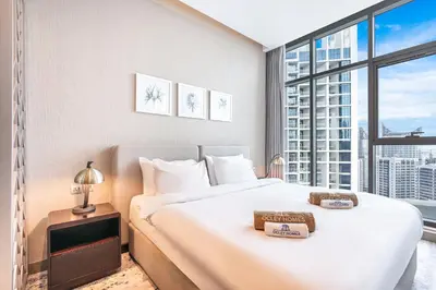 a bedroom with a large bed and a large window at Modern Home in Business Bay with Panoramic View in Dubai