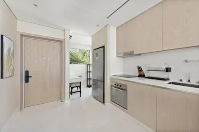 a kitchen with a door leading to a dining room at Stunning 1-BR Apartment In Heart Of The Palm in Dubai