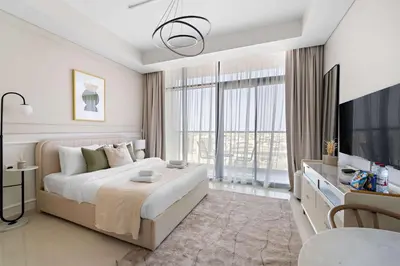 a bedroom with a large bed and a large window at Silkhaus New Modern Studio In New Tower at Business Bay in Dubai
