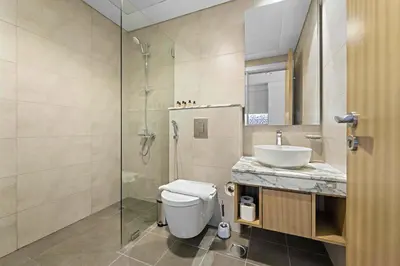 a bathroom with a toilet and a sink and a shower at Silkhaus New Modern Studio In New Tower at Business Bay in Dubai