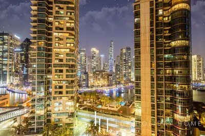 a view of a city at night with tall buildings at LUX The Luxurious Central JBR Suite 2 in Dubai