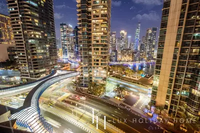 a city skyline at night with traffic and buildings at LUX The Luxurious Central JBR Suite 2 in Dubai