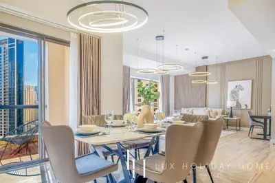 a dining room and living room with a table and chairs at LUX The Luxurious Central JBR Suite 2 in Dubai