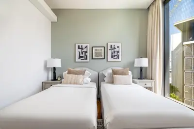 two beds in a room with a window at GuestReady - Magnificent stay in Bluewaters Island in Dubai