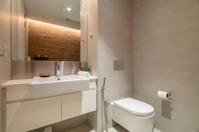 a bathroom with a white toilet and a sink at GuestReady - Magnificent stay in Bluewaters Island in Dubai