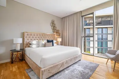 a bedroom with a large bed and a large window at GuestReady - Magnificent stay in Bluewaters Island in Dubai