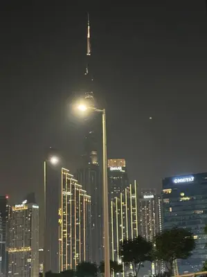 a city skyline at night with a tall building at Layali - Chic 1BR with Balcony in Business Bay in Dubai