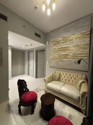 a living room with a couch and a chair at Layali - Chic 1BR with Balcony in Business Bay in Dubai