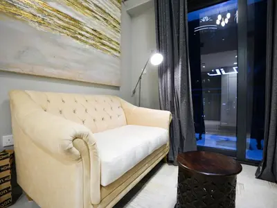 a living room with a couch and a window at Layali - Chic 1BR with Balcony in Business Bay in Dubai