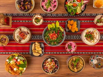 a table with many plates of food on it at Cosmos Living Sleek and Stylish GCV2 in Dubai
