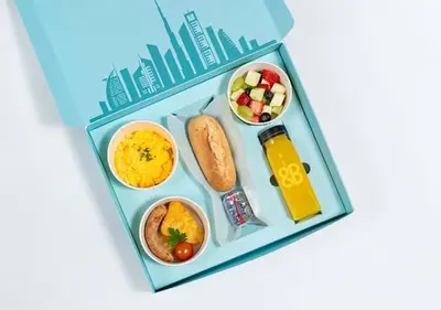 a bento box filled with food and drinks at Cosmos Living Sleek and Stylish GCV2 in Dubai