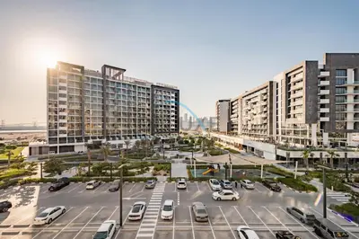 an aerial view of a parking lot with tall buildings at Calming Studio Apartment at Azizi Riviera 4, Al Merkadh by Deluxe Holiday Homes in Dubai