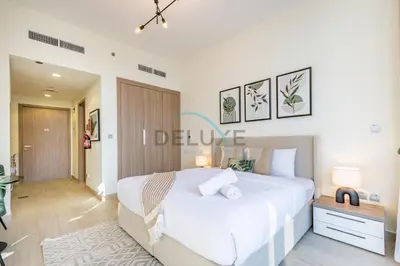 a bedroom with a large white bed in a room at Calming Studio Apartment at Azizi Riviera 4, Al Merkadh by Deluxe Holiday Homes in Dubai