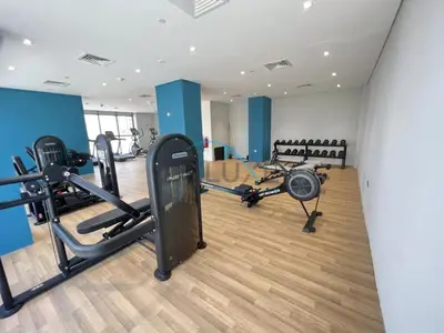 a gym with treadmills and machines in a room at Calming Studio Apartment at Azizi Riviera 4, Al Merkadh by Deluxe Holiday Homes in Dubai