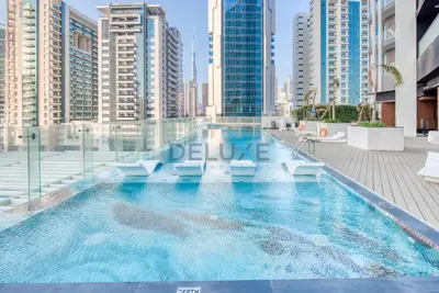 a swimming pool in a city with tall buildings at Weekly Deal 3BR with Overlooking Canal & City Views by Deluxe Holiday Homes in Dubai
