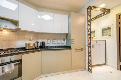 a kitchen with white cabinets and appliances at Weekly Deal 3BR with Overlooking Canal & City Views by Deluxe Holiday Homes in Dubai