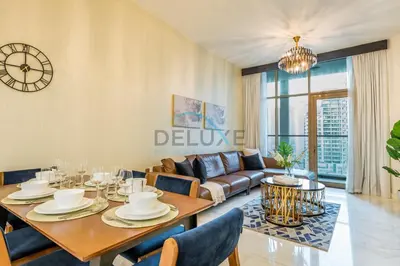 a living room with a table and a couch at Weekly Deal 3BR with Overlooking Canal & City Views by Deluxe Holiday Homes in Dubai