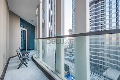 a balcony with a chair and a view of a city at Weekly Deal 3BR with Overlooking Canal & City Views by Deluxe Holiday Homes in Dubai