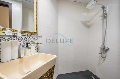 a bathroom with a sink and a shower at Weekly Deal 3BR with Overlooking Canal & City Views by Deluxe Holiday Homes in Dubai