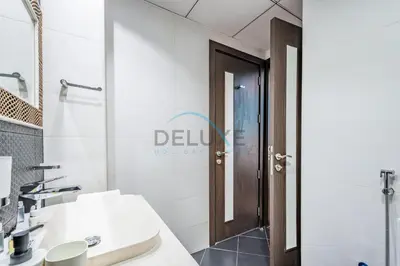 a white bathroom with a sink and a mirror at Weekly Deal 3BR with Overlooking Canal & City Views by Deluxe Holiday Homes in Dubai