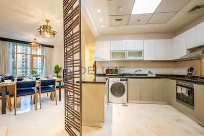 a kitchen with a washer and a dining room at Weekly Deal 3BR with Overlooking Canal & City Views by Deluxe Holiday Homes in Dubai