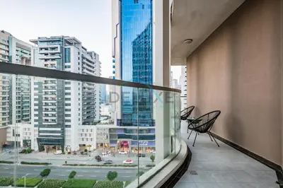 a balcony with a view of a city with tall buildings at Stunning 3BR Apartment in Bayz Tower, Business Bay by Deluxe Holiday Homes in Dubai