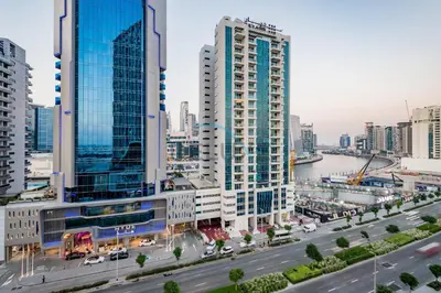a city skyline with tall buildings and a river at Stunning 3BR Apartment in Bayz Tower, Business Bay by Deluxe Holiday Homes in Dubai